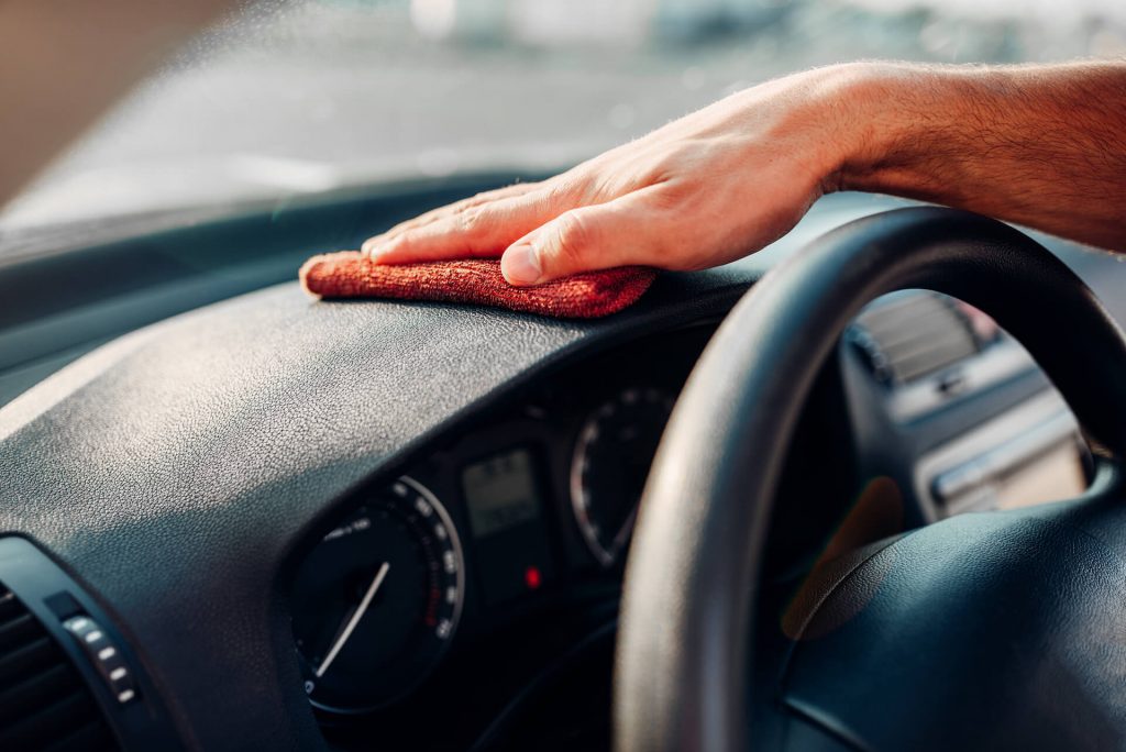 male hands cleans auto car dashboard polishing 2021 08 26 16 25 48 utc 2